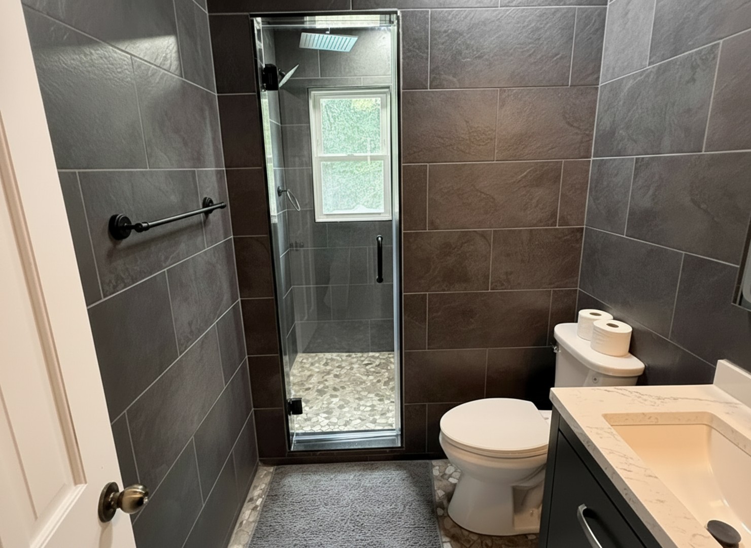 Step into the spacious shower with a rainfall showerhead and pebble-stone floor to refresh after a day of adventures.